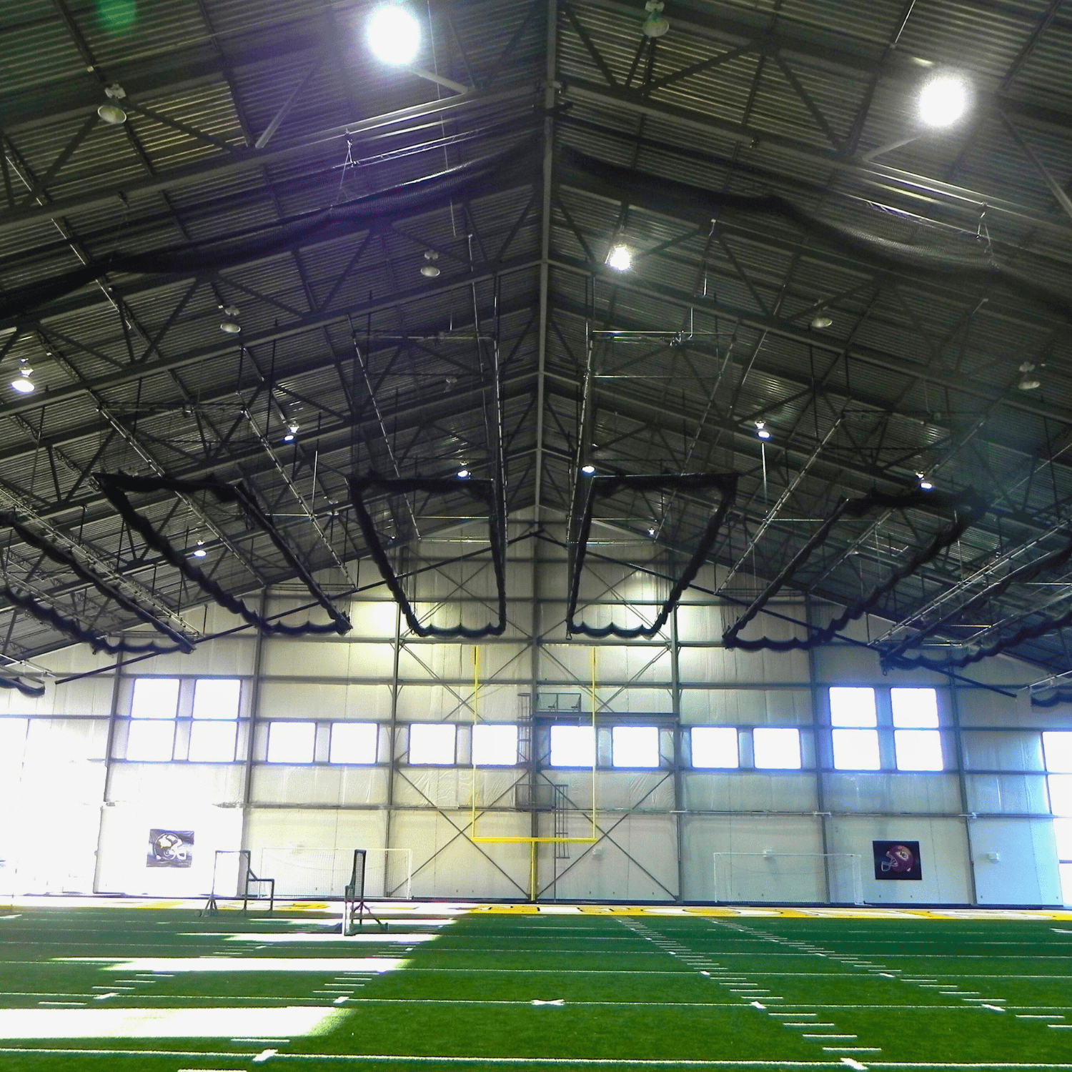 indoor batting cage nets suspended from the ceiling in gymnasium
