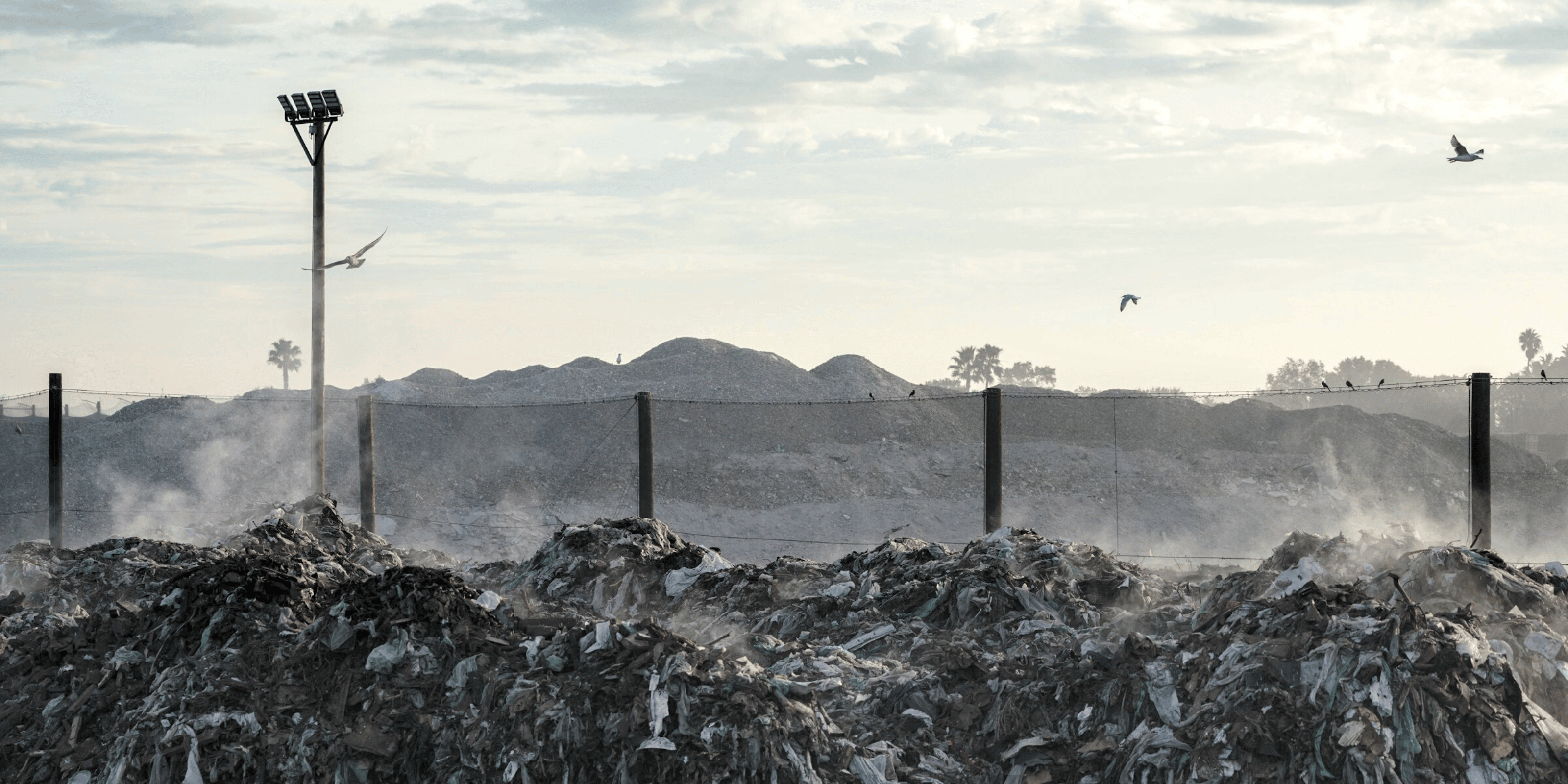 Landfill and debris netting system holding in the trash from the landfill site