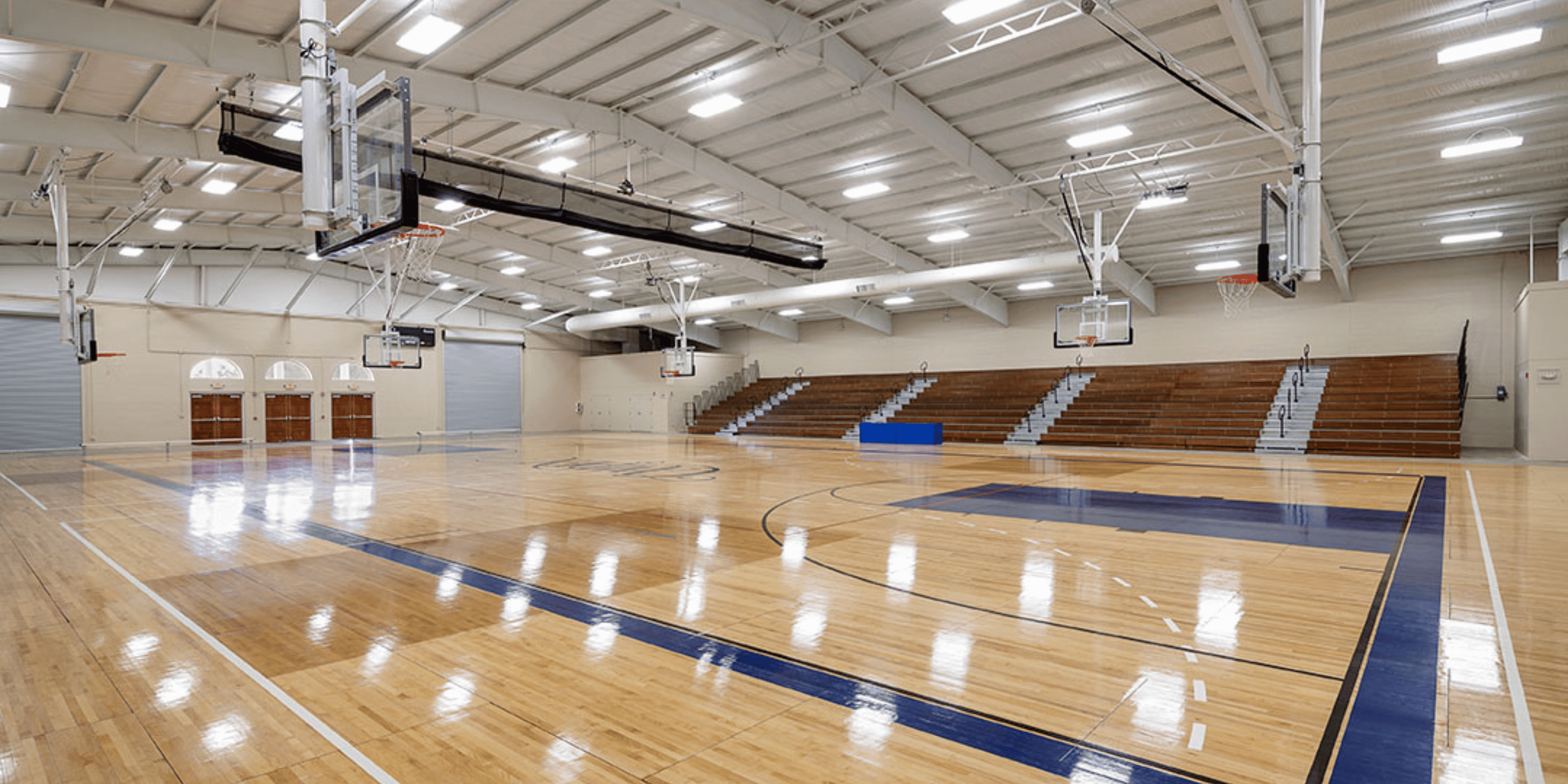 School gymnasium with curtain divider net rolled up to the ceiling